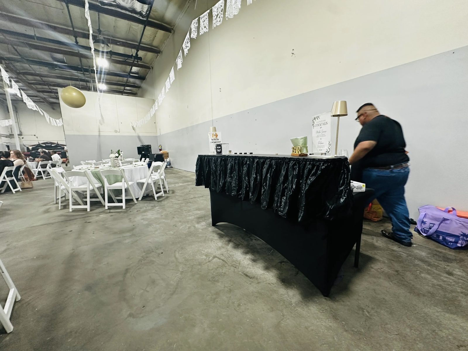 Signature cocktails menu, tip jar, and bar setup at an Orange, CA wedding